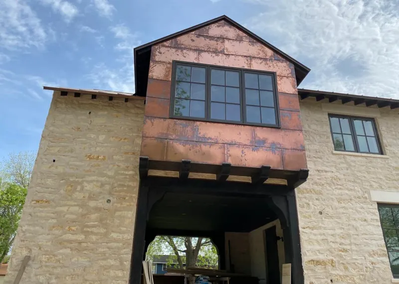 Copper metal panel facade on a stone building for Skylight Installation in Pequea