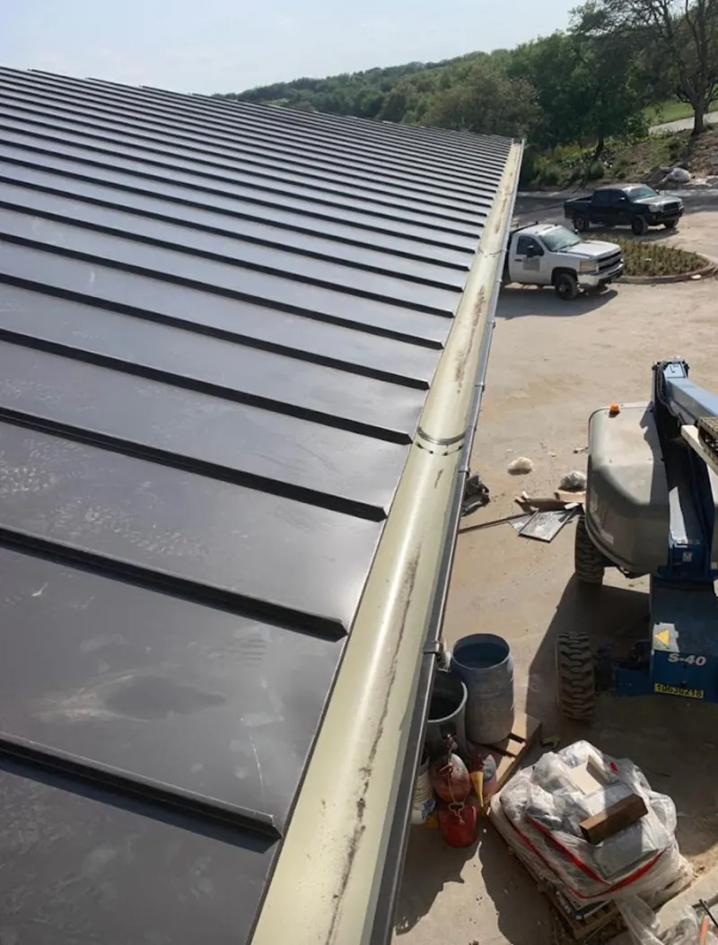 Standing seam panel and gutter detail on a metal roofing jobsite in Pequea